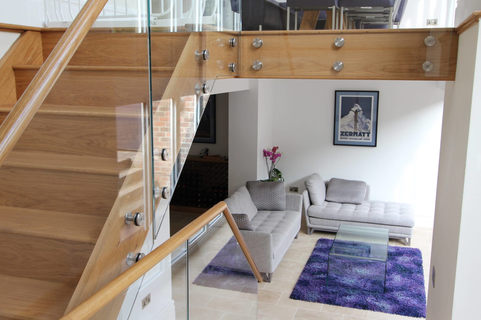 a living room with a couch and a stair case.